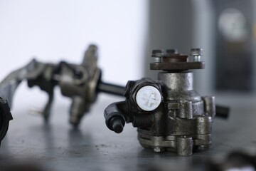 Different auto parts on grey table indoors, closeup