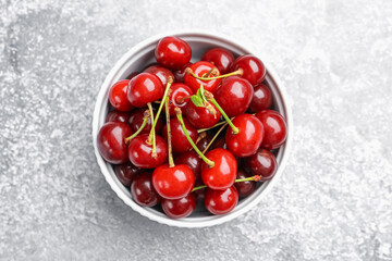 Fresh ripe cherries on light table, top view