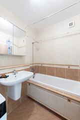 Modern Bathroom Interior with Tub and Sink in Neutral Tiled Design