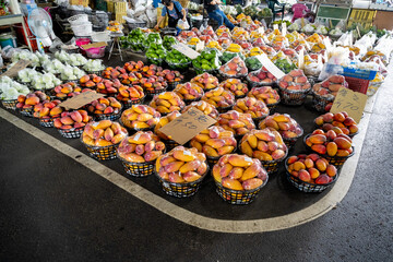 Tainan, Taiwan – Jun 30, 2025: Display of fresh mangoes at Yujing Fruit Market. The market is a major hub for Taiwan’s mango harvest, attracting locals and tourists during summer fruit season.