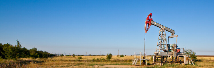 oil pump against sky background banner