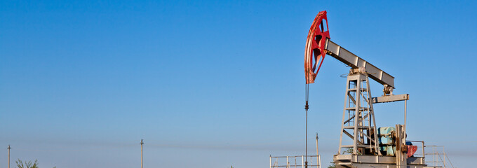 oil pump against sky background banner