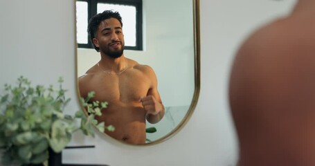 Man, mirror and flexing biceps in bathroom for fitness progress, muscle growth and workout results. Male person, reflection or inspection of body transformation, grooming routine and strength in home - Powered by Adobe