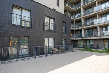 Modern Apartment Building Exterior with Balconies and Open Outdoor Space