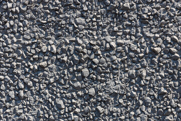 A surface covered in crushed gravel. Decorative wall. Background, pattern