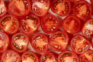 Small ripe tomatoes cut into halves macro top view
