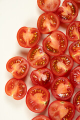 Small ripe tomatoes cut into halves macro top view