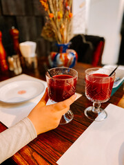 Enjoying refreshing drinks at a cozy table setting in a vibrant eatery during the day