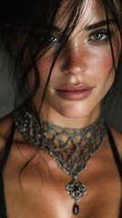 Close-up portrait of a woman showcasing intricate jewelry in soft lighting