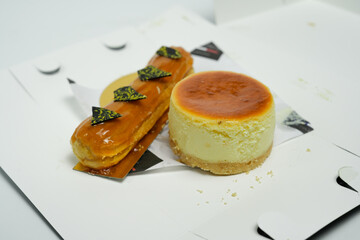 delicious pastries highlighting eclair and cheesecake on white background