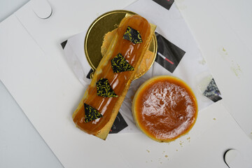 delicious pastries highlighting eclair and cheesecake on white background