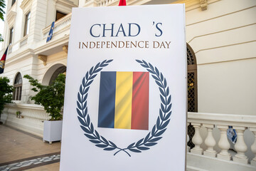 Chad's Independence Day Sign: A sign celebrating Chad's Independence Day, the foreground of a building or public space, the flags representing the nation are clearly visible in the frame.