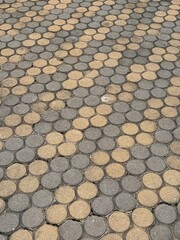 Cement walkway decorated with hexagonal concrete paving slabs.