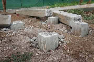 Prestressed concrete square piles are cut above the ground surface to prepare for pile foundation...