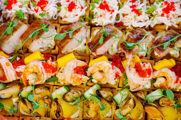A box with an assortment of meat and fish appetizers for the buffet table.