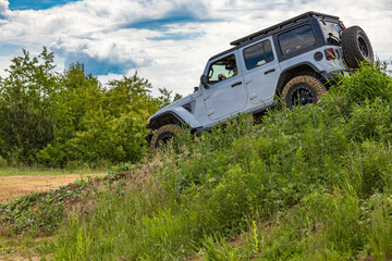 Fototapeta premium Off-road vehicle in difficult terrain, off-road car rally, off-road car group races