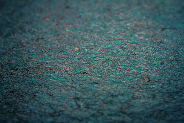 Extreme closeup of turquoise handmade paper with shallow depth of field.