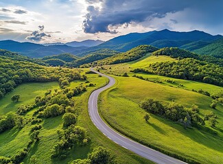 Beautiful, winding asphalt road in the mountains, with a green forest and meadow in the background. Summertime. Beautiful natural landscape of northern Italy. Panorama. Stock photo contest winner, pho