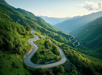 Beautiful, winding asphalt road in the mountains, with a green forest and meadow in the background. Summertime. Beautiful natural landscape of northern Italy. Panorama. Stock photo contest winner, pho