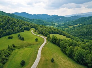 Beautiful, winding asphalt road in the mountains, with a green forest and meadow in the background. Summertime. Beautiful natural landscape of northern Italy. Panorama. Stock photo contest winner, pho