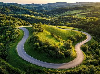 Beautiful, winding asphalt road in the mountains, with a green forest and meadow in the background. Summertime. Beautiful natural landscape of northern Italy. Panorama. Stock photo contest winner, pho
