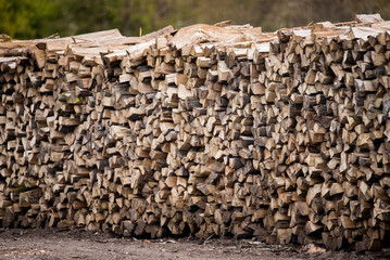 Dry oak wood ready for heating. Wooden logs stacked on top of each other. Stack of wood, firewood,...