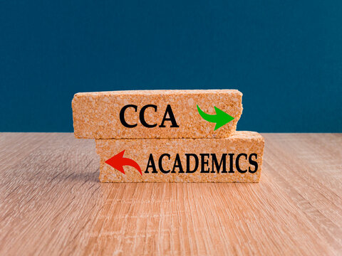 Academics and cca as different choices in life - pictured as words Academics, cca on brick blocks with pointing at opposite ways to show that these are alternative options.