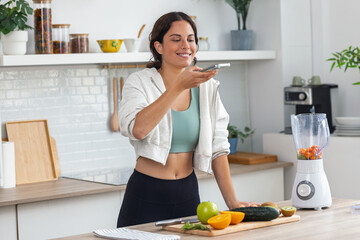Influencer woman talking about nutrition to her followers while recording with smartphone in the...