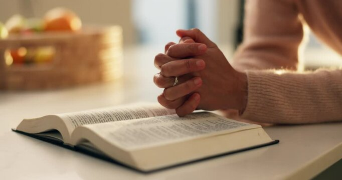 Prayer hands, reading and bible study in home, faith and scripture review for spiritual guide with hope. Person, book and knowledge for Christian religion, story and holy literature for God at house