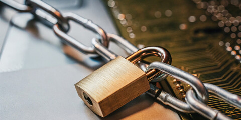 Abstract background in technology. Padlock and chains on the circuit board in the concept of...