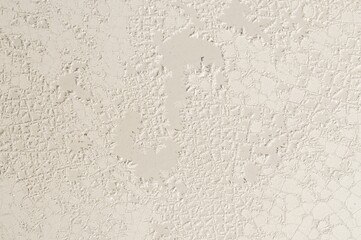 Detailed close-up of a cracked and textured white painted surface, creating an aged effect.