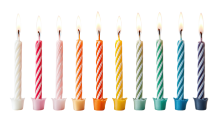 Festive arrangement of colorful birthday candles with lit flames against black background