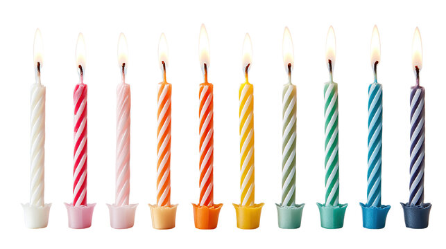 Festive arrangement of colorful birthday candles with lit flames against black background