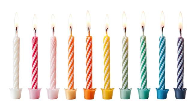 Festive arrangement of colorful birthday candles with lit flames against black background