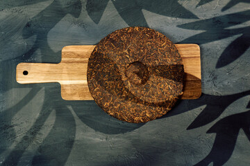 Discovering the rich texture and aroma of puer tea on a wooden board in a serene setting