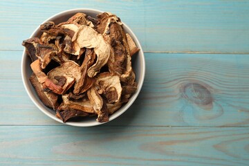 Dried chanterelle mushrooms on blue wooden table, top view. Space for text