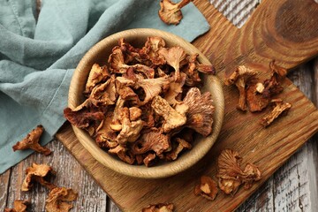 Dried chanterelle mushrooms on wooden table, flat lay