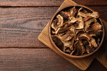Dried chanterelle mushrooms on wooden table, top view. Space for text