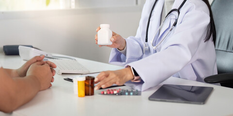 Doctor explaining medication options to patient during consultation in clinic.