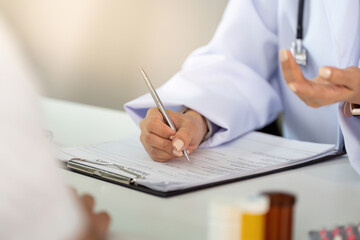 Doctor taking notes during patient consultation in modern healthcare setting.