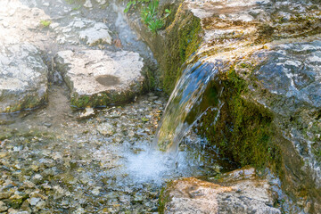 Tranquil waterfall flowing over mossy rocks in a serene natural setting