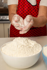Hands of Elderly Woman Covered in Flour