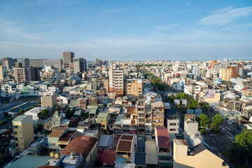 Tainan, Taiwan – Jun 30, 2025: Aerial view of Tainan City urban landscape under bright blue sky....