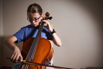 Young Musician Practicing The Cello at Home with Dedicated Focus