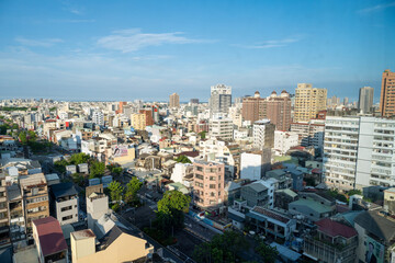 Tainan, Taiwan – Jun 30, 2025: Aerial view of Tainan City urban landscape under bright blue sky....