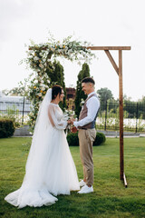 wedding ceremony of a young couple in love on a green meadow