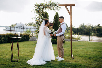 wedding ceremony of a young couple in love on a green meadow
