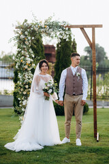 wedding ceremony of a young couple in love on a green meadow