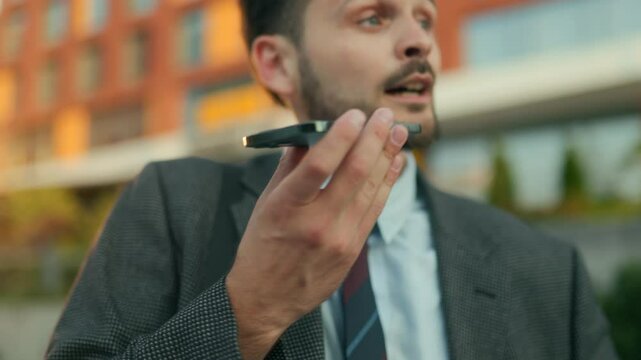 Young office worker rushing on phone juggling coffee in city morning rush