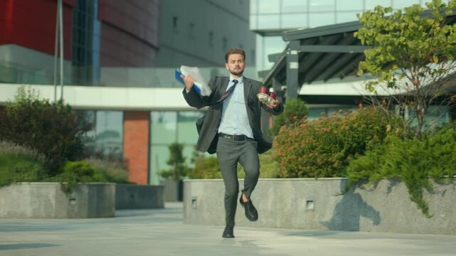 Stressed office guy running late with coffee and documents flying
